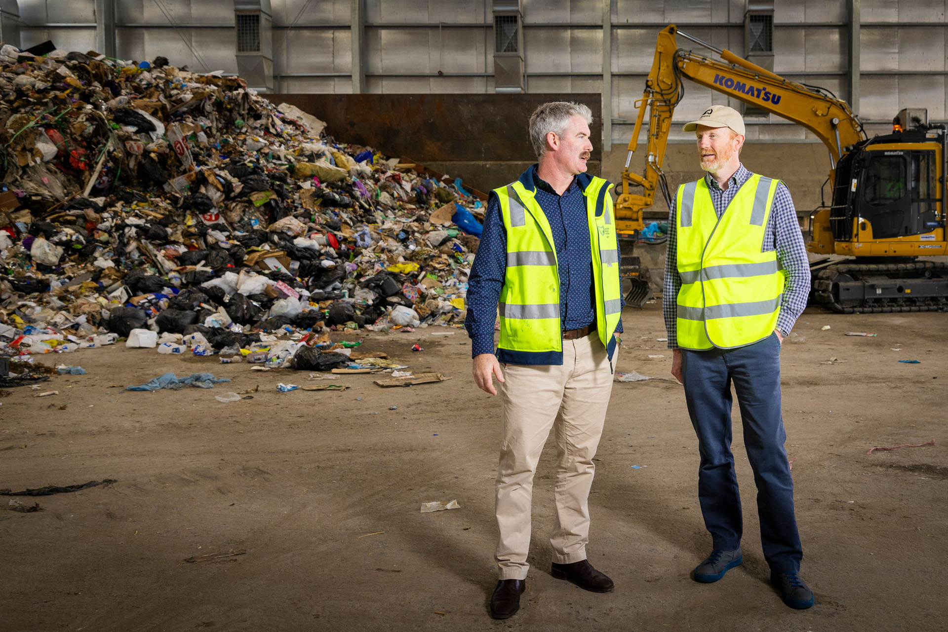 Landcare and Southern Waste Solutions Schools initiative two men in high vis standing in front of rubbish pile